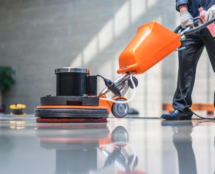 Side view of a man buffing clean floors
