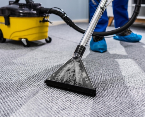 Worker cleaning commercial office carpet