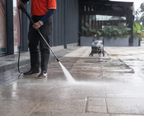 Worker pressure washing