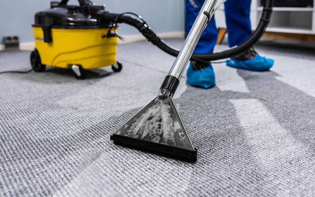 Worker cleaning commercial office carpet