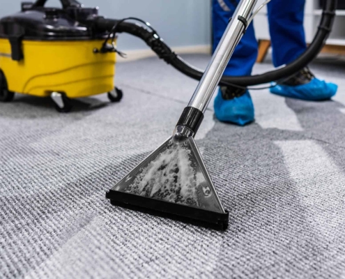 Worker cleaning commercial office carpet