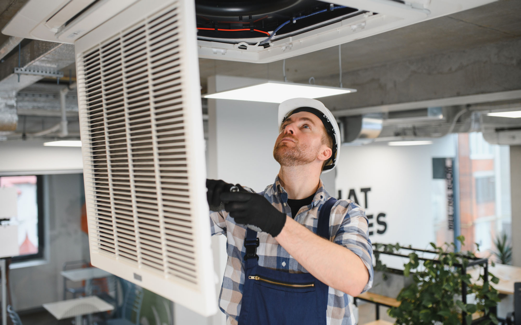 Building Maintenance Worker Looking At Hvac